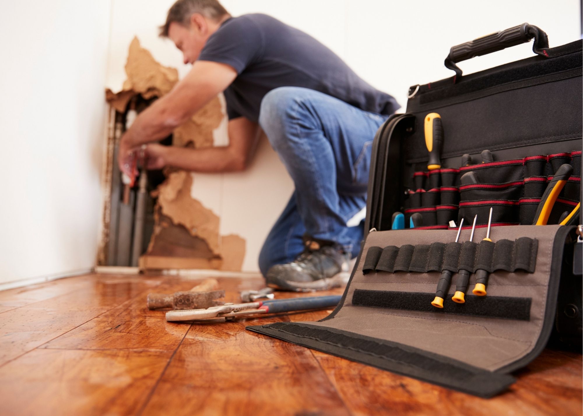 Restoration technician placing drying equipment in an Edgewater home